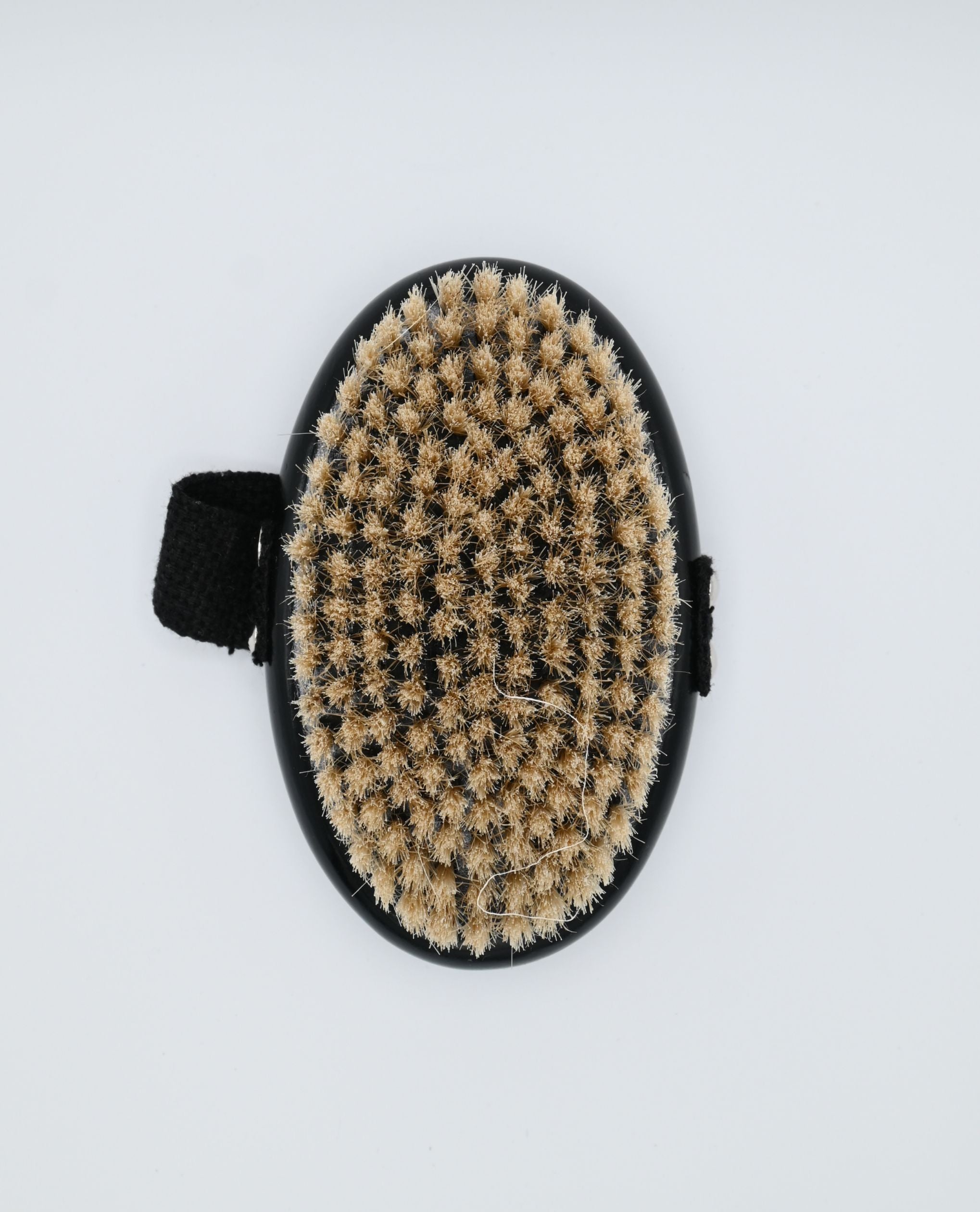 Oval dry body brush with natural bristles and minimalist black design