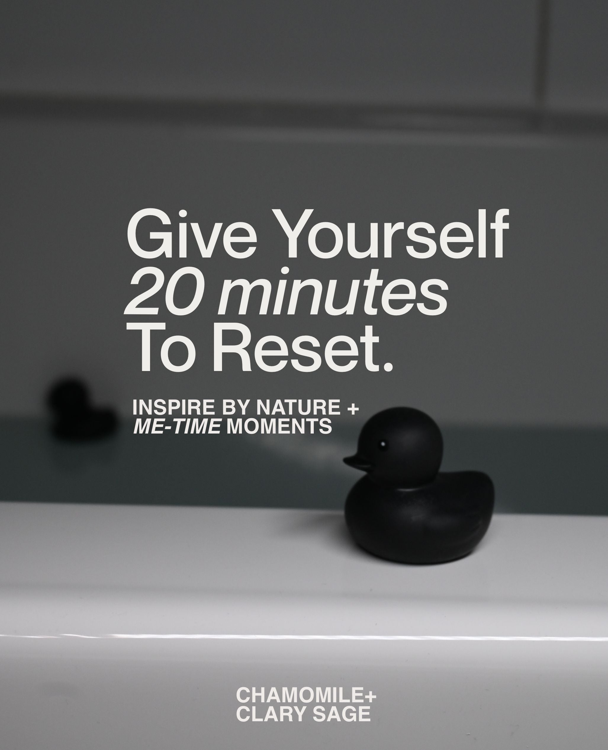 Matte black rubber duck beside bathtub in calming bath salt self-care setting