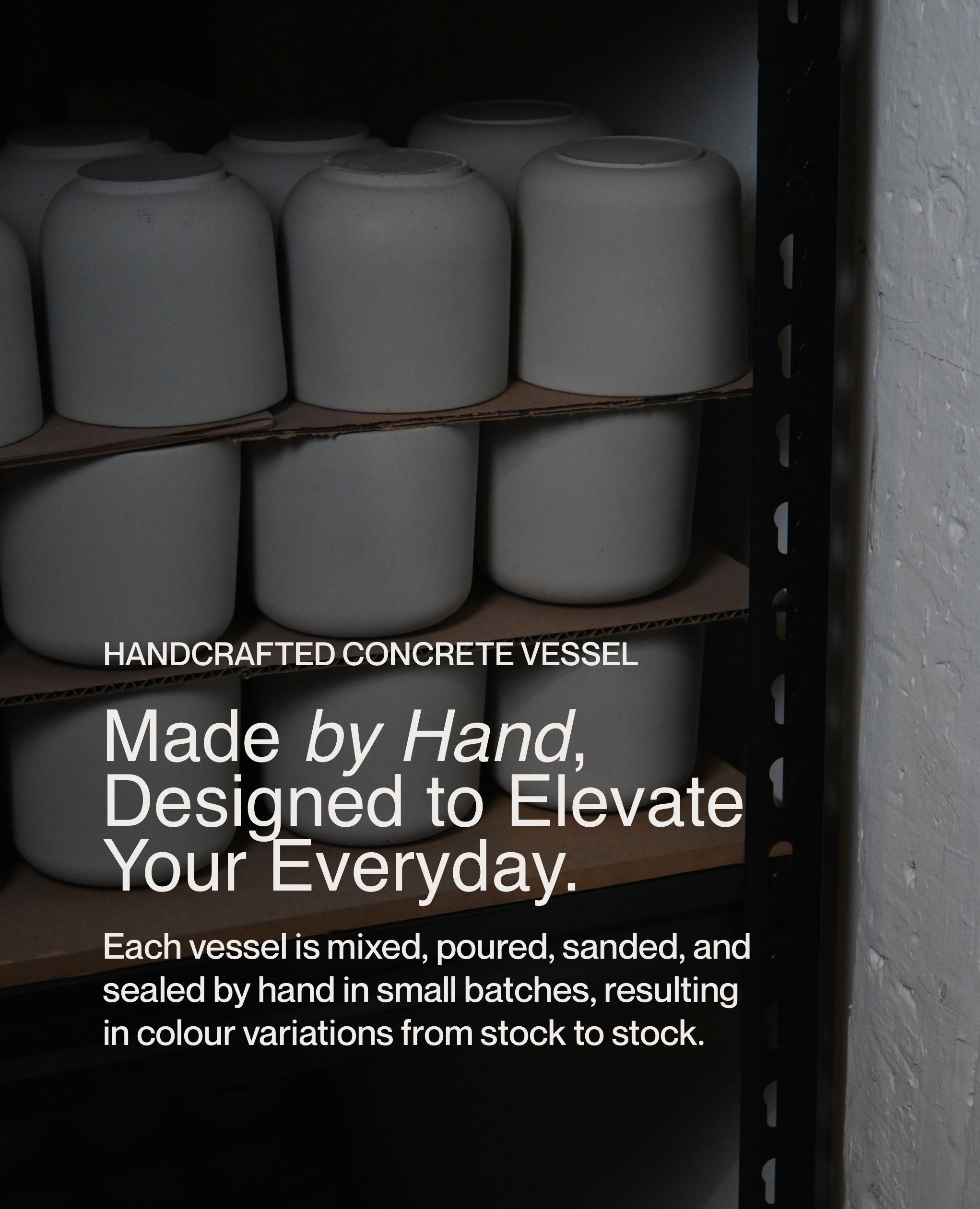 Handcrafted concrete soy wax candle vessels drying on shelves in small-batch studio production