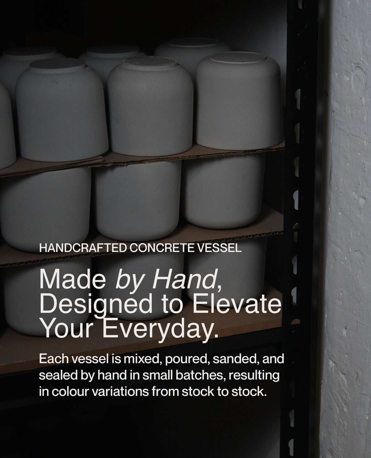 Handcrafted concrete soy wax candle vessels drying on shelves in small-batch studio production